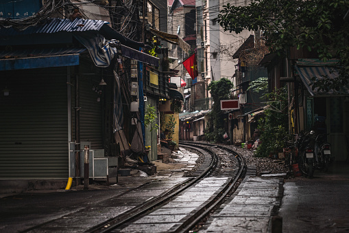 Hanoi, Vietnam - November 26, 2018: Crossroad at famous touristic place , railway through the narrow street Trần Phú