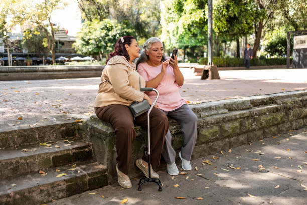 istock Two senior women using mobile phone 1352313283