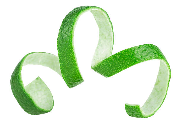 istock Curly lime peel twist isolated on a white background. Cocktail ingredient. Fresh lime fruit peel. 1352313895