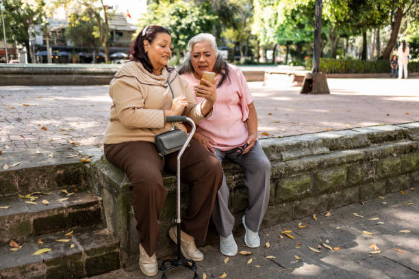 istock Two senior women looking at mobile phone 1352314009