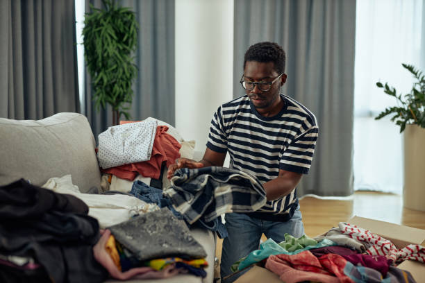 istock Young black male puts donations in a box 1352314436