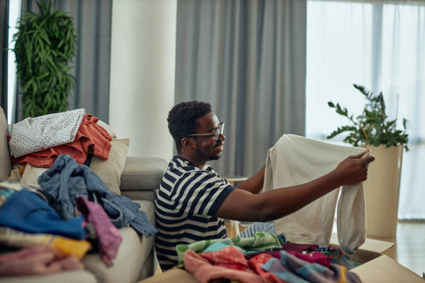istock Young black man donating clothes to charity 1352314553