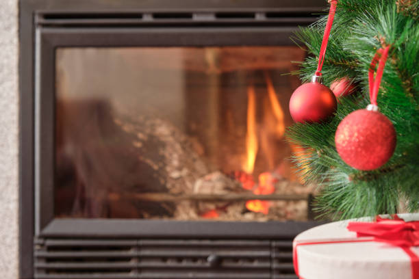 istock Christmas tree with red balls and fireplace in background 1352315717