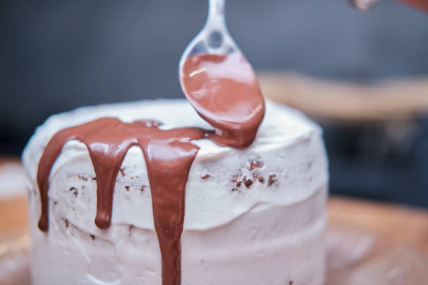 istock Place liquid chocolate with a spoon on top of the cake 1352316916