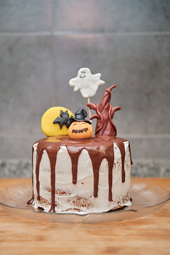 Halloween cake with bat, tree trunk, pumpkin and ghost made with sugar paste