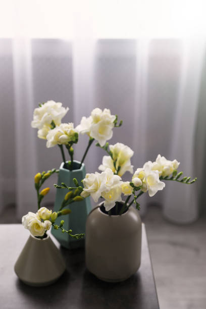 istock Beautiful spring freesia flowers on table in room 1352318444