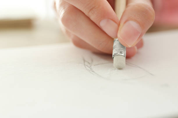 istock Woman correcting picture in notepad with pencil eraser, closeup 1352319451