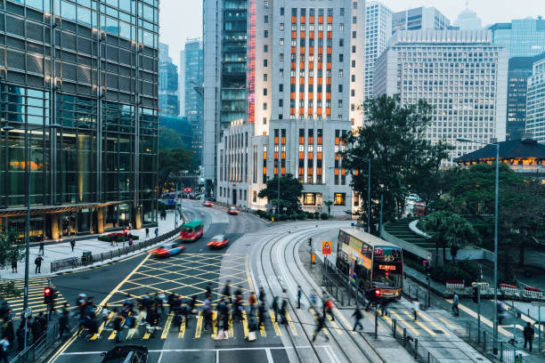 Pedestrians crossing street in Central Hong Kong, China stock photo