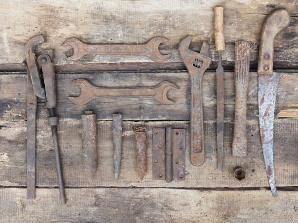 istock Close-up of old rusty tools lying on a wooden background 1352319523