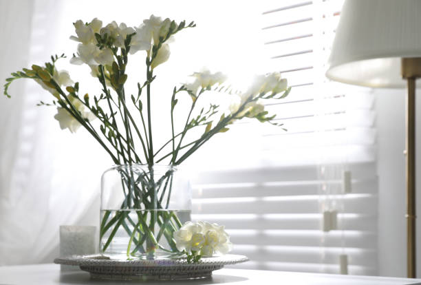 istock Beautiful spring freesia flowers on table in room 1352321638