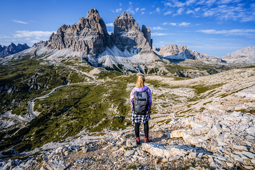 Woman hiker exploring Tre Cime di Lavaredo national park. Trentino-Alto-Adige, Dolomiti, Italy.