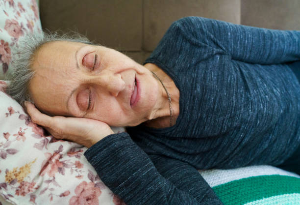 istock Senior woman snoring 1352322099