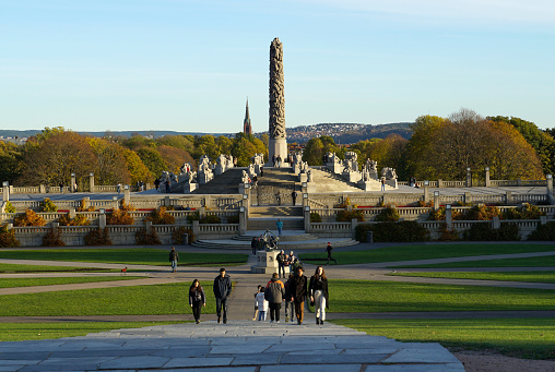 Oslo, Norway, 23rd October, 2021. Autumn sunday evening in Vigeland park in Oslo with big monolith sculpture in the background