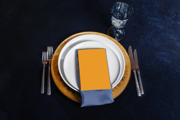 istock Festive table setting with blue silk ribbon and gold pads. Festive wedding, birthday table setting. Restaurant empty menu mock up. 1352323667