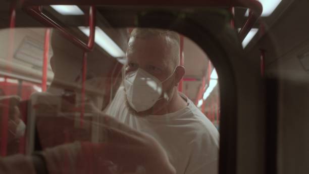 istock Carriage passengers train. Male passengers wearing masks Shooting through glass 1352325132