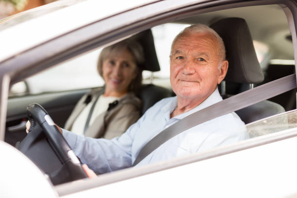 istock Senior couple sitting in car 1352328241