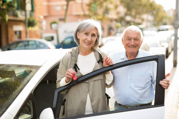 istock Senior couple standing beside car 1352328248