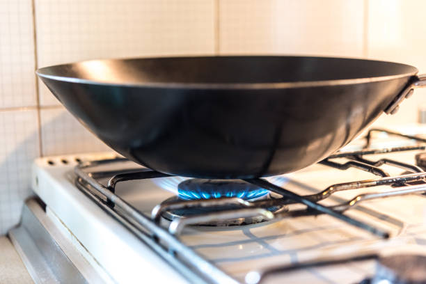 istock Wok on Gas Stove in Domestic Kitchen 1352329225