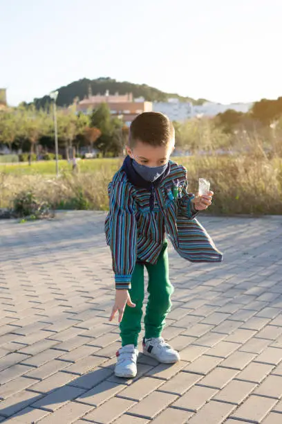 Photo of Boy launching firecrackers  known as Bombetas in Valencian fallas festivals