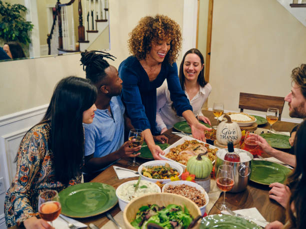 istock Friends Celebrating Thanksgiving Dinner Together 1352330851
