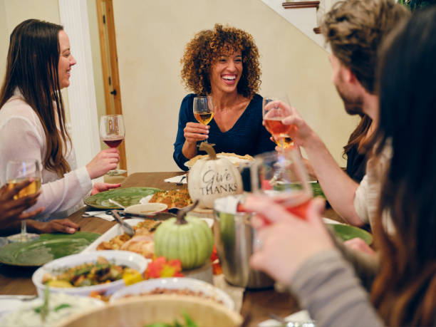 istock Friends Celebrating Thanksgiving Dinner Together 1352331055