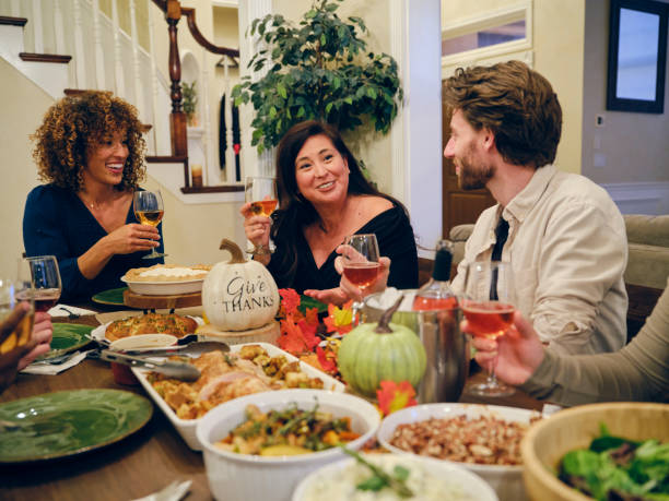 istock Friends Celebrating Thanksgiving Dinner Together 1352331085