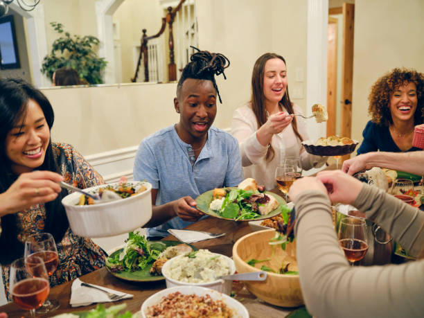 istock Friends Celebrating Thanksgiving Dinner Together 1352331139