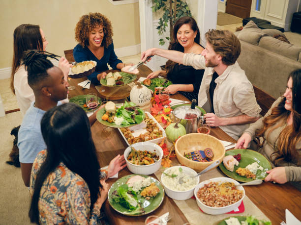 istock Friends Celebrating Thanksgiving Dinner Together 1352331173