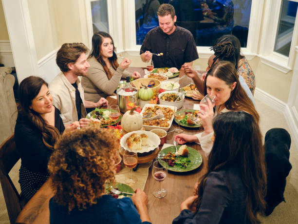 istock Friends Celebrating Thanksgiving Dinner Together 1352331221