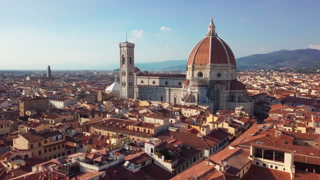 Aerial view. Historically and Culturally Rich Italian Town on the Sunny Day. Beautiful Old City With Medieval Churches and Cathedrals. Clouds in the background