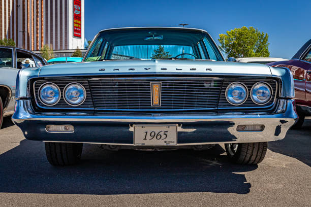 Image of a classic American 1962 luxury style vehicle with focus on it's head lights and grill