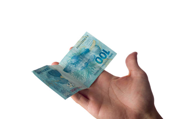 istock man holding hundred reais bills isolated on white. Brazilian money. 1352336607