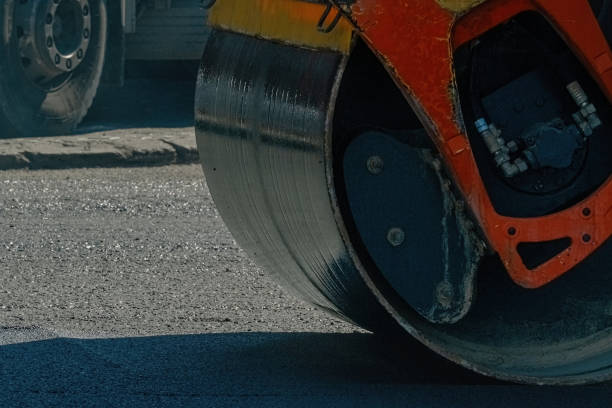 istock Asphalt paver at work close up 1352339011