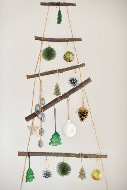istock Handmade wooden Christmas tree hanging on the wall 1352339978