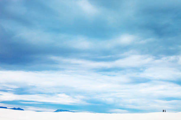 Desert landscape with people in background. White Sands, New Mexico, US.