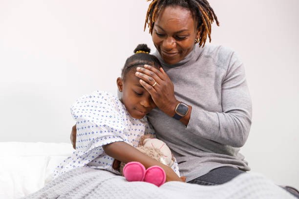 istock Hospitalized girl with supportive and loving mom 1352346315