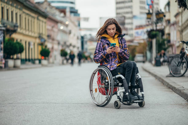 istock Woman with disability using a smartphone while out in the city 1352346825