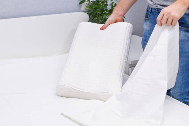 istock A man puts a pillowcase on orthopedic pillow. 1352352637