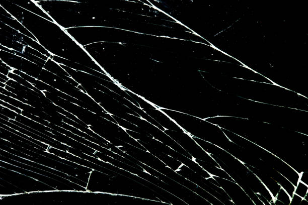 istock cracked glass isolated on a black background. broken glass 1352355618