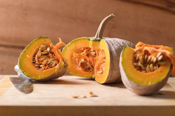 istock Sliced organic Asian pumpkin on wooden board 1352355738