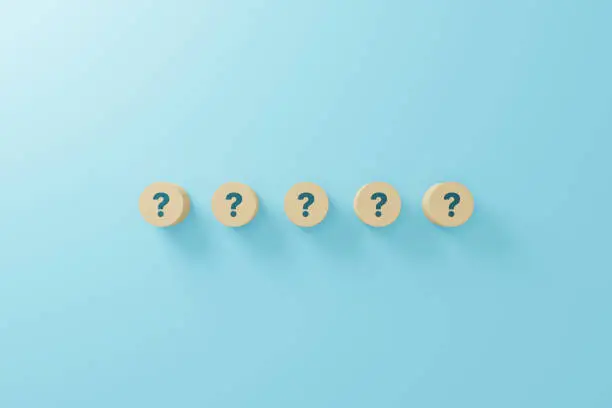 Photo of Wooden block shape with sign question mark symbol on blue background. 3d render illustration