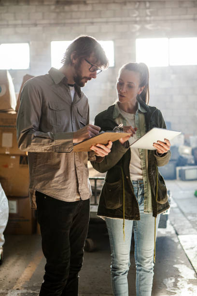 istock Male and female recycling warehouse workers discussing over digital tablet 1352362702