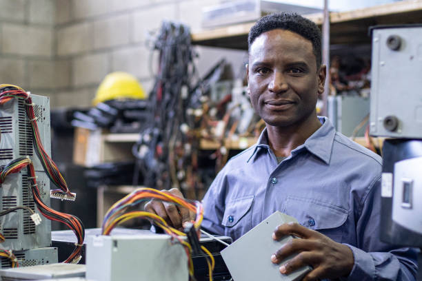 istock African american male e-waste recycling worker looking at the camera while holding computer components 1352363305