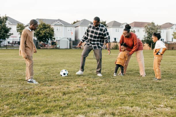 istock Playing soccer together with kids 1352363905