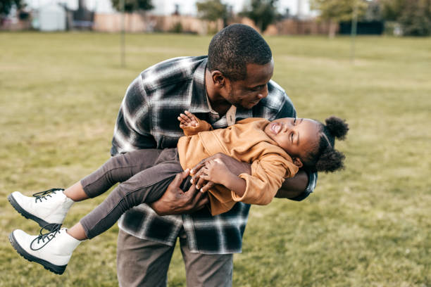 istock Dad playing with his daughter outside 1352363911