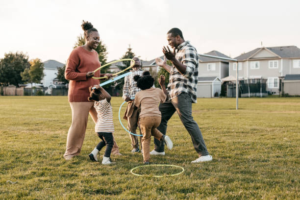 istock Family playing outside with hula hoops 1352363912