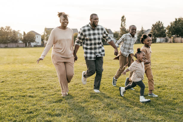 istock Happy parents and running kids outside 1352363928