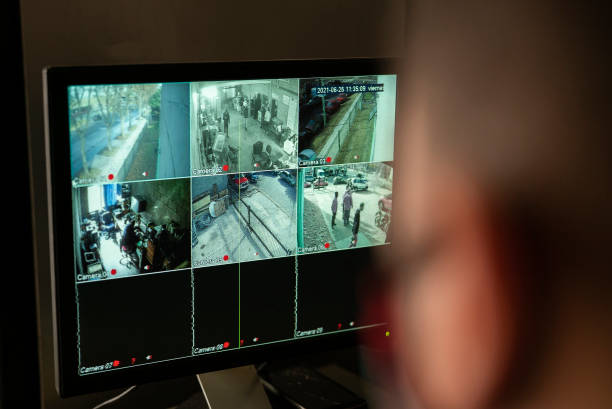 istock Security guard watching video monitoring 1352364213