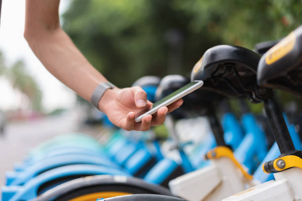 istock Asian man uses his mobile phone to scan the QR code to unlock the shared bicycle 1352372062