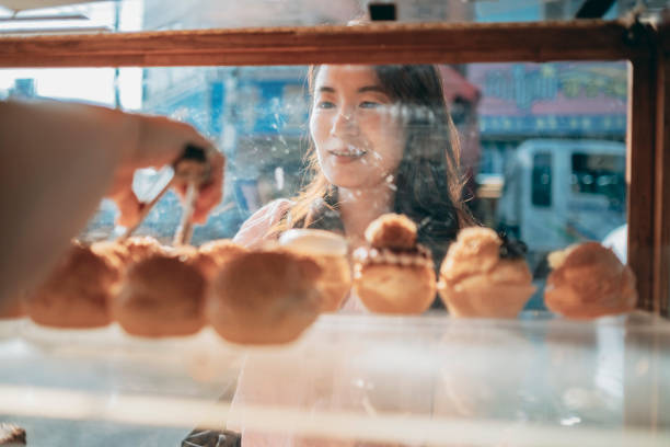 istock Guests buy cream puffs 1352373779